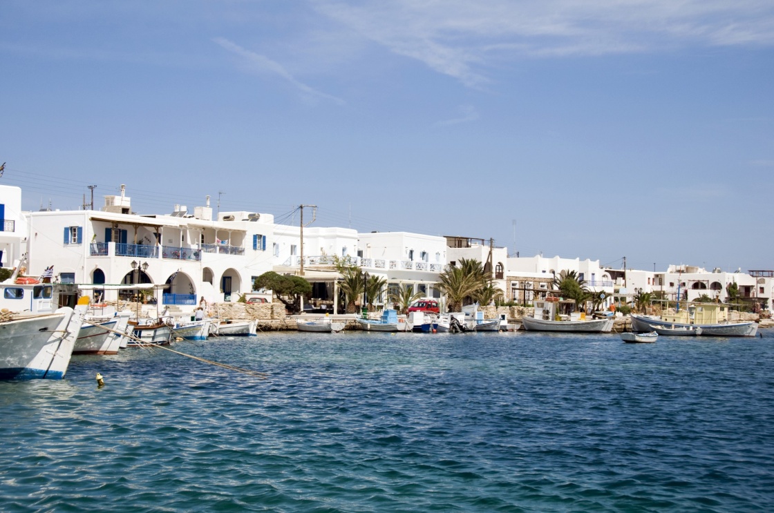 'the beautiful  classic port harbor of antiparos island in the cyclades greece with boats and hotels and classic greek island architecture' - Paros