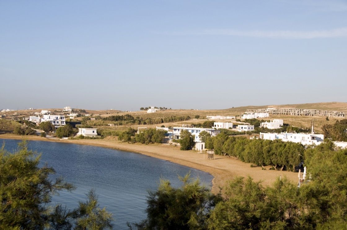 logaras beach with typical greek island architecture and hotel development and cypress trees on the cyclades island of paros greece in the mediterranean sea